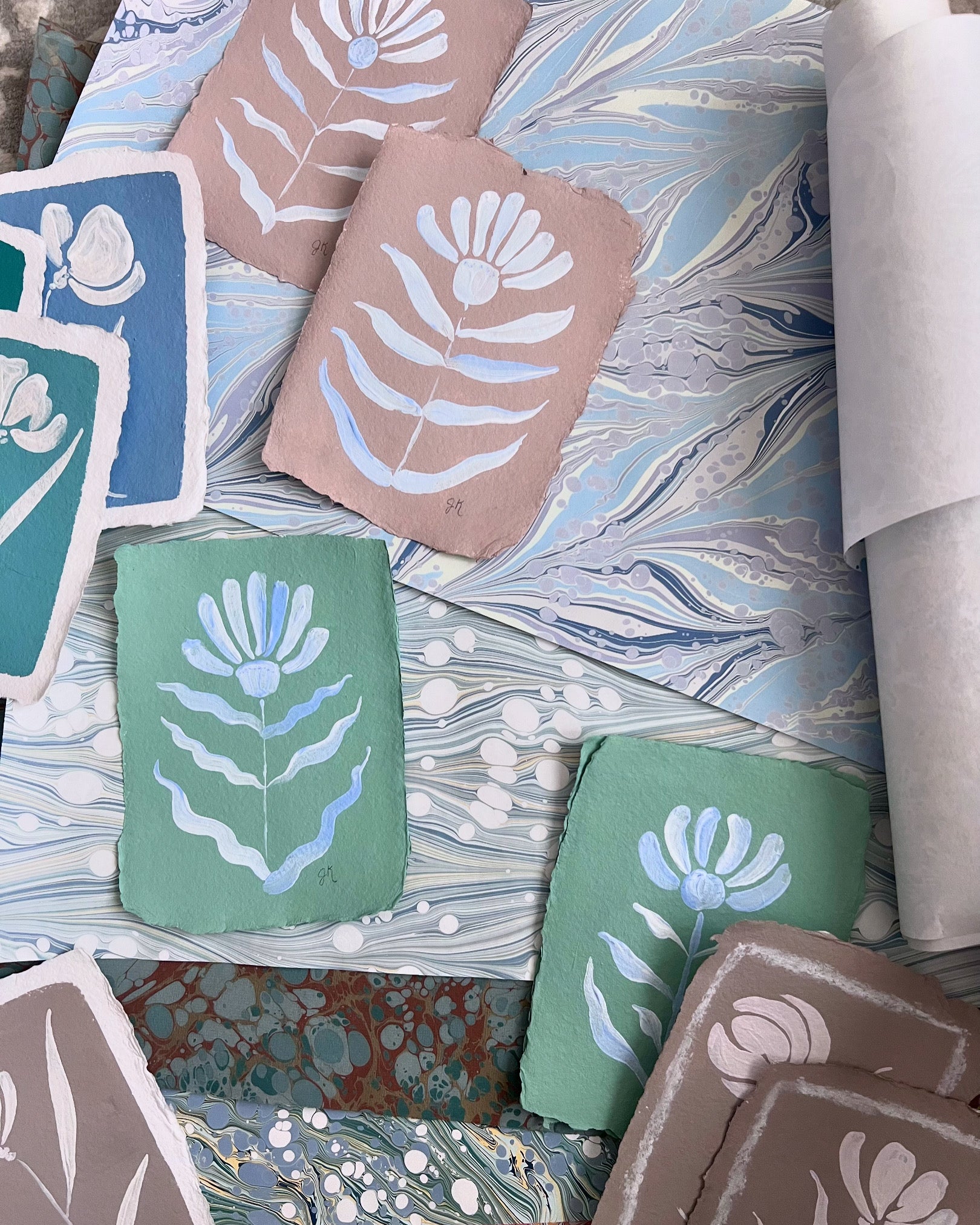 Collection of fabric swatches with floral patterns on a textured surface